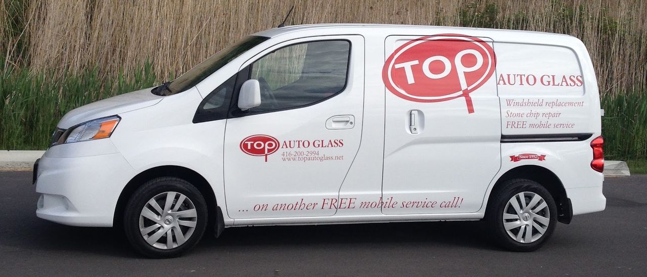White Top Auto Glass service van with the TOP logo, phone number and 'FREE mobile service' on the side